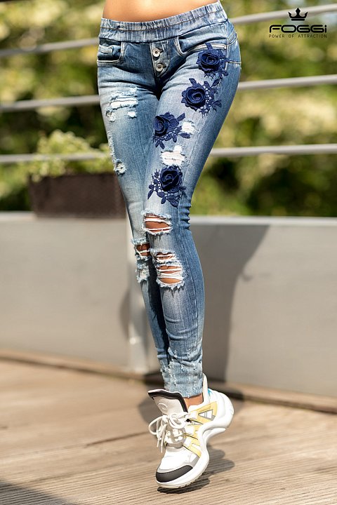 Jeans slim bllu  con fiori blu con cinta elastica in vita.