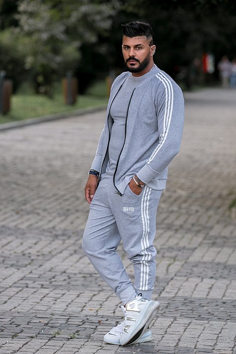Men's sports suit in light gray with white side bands. 