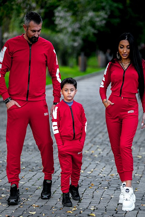 Red sports suit for girls with white patches.