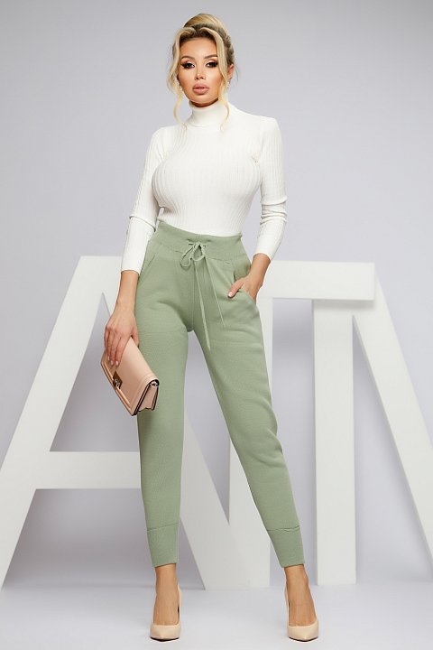 Green knitted trousers with a slightly sporty style.