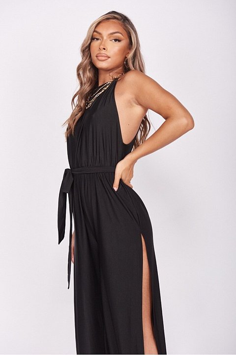 Elegant black jumpsuit with thin straps. model with slit on both legs.