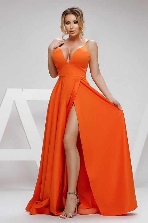 The long orange dress with split ends is an elegant evening dress that will make you stand out. The long dress has a bust with a deep terry neckline. The dress 