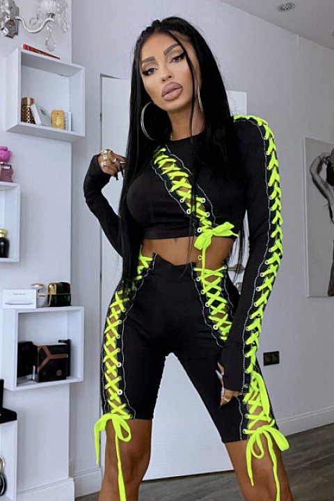 2-piece black set with neon yellow cord inserts. Consisting of a long-sleeved blouse and fitted shorts.
