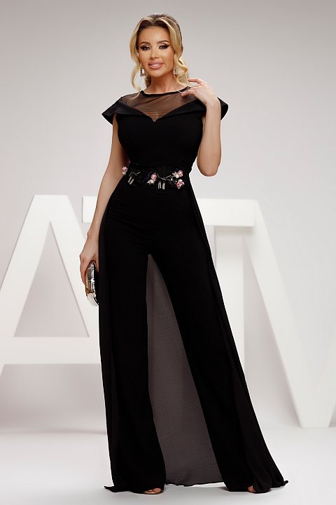 Elegant black jumpsuit with train. The jumpsuit has a deep tulle neckline and the embroidery at the waist transforms the whole outfit.
