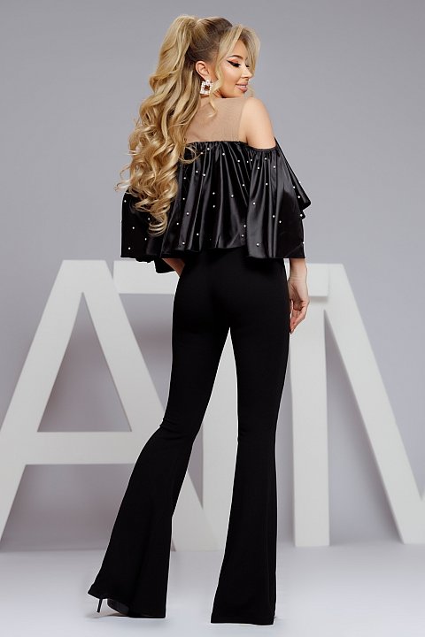 Black satin blouse at the base of the neck.