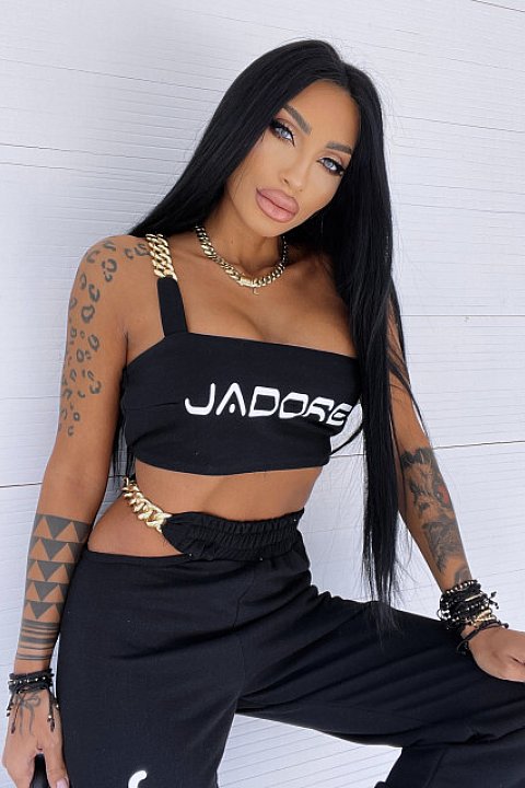 2-piece set consisting of a top with chain straps and high-waisted trousers with buckles. Fantasy with lettering and black print.