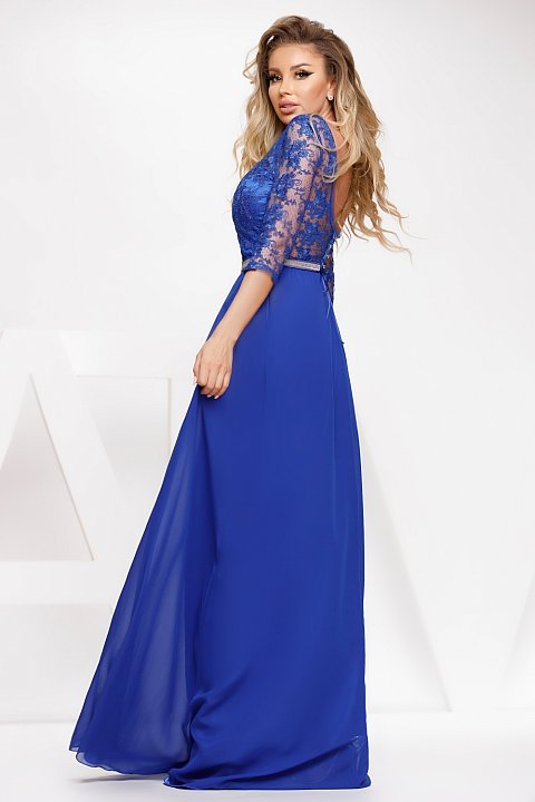 Long blue veil dress with lace insert and rhinestone belt at the waist.