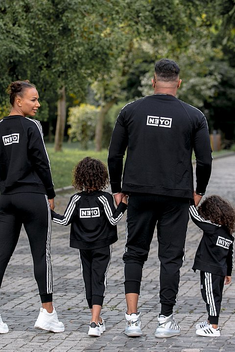 Girl / Boy black sports suit with white side bands.