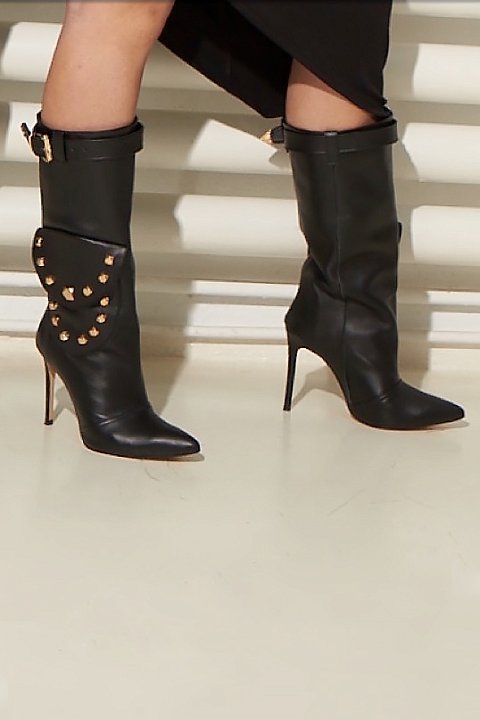 Black leather boots with golden studs. 
