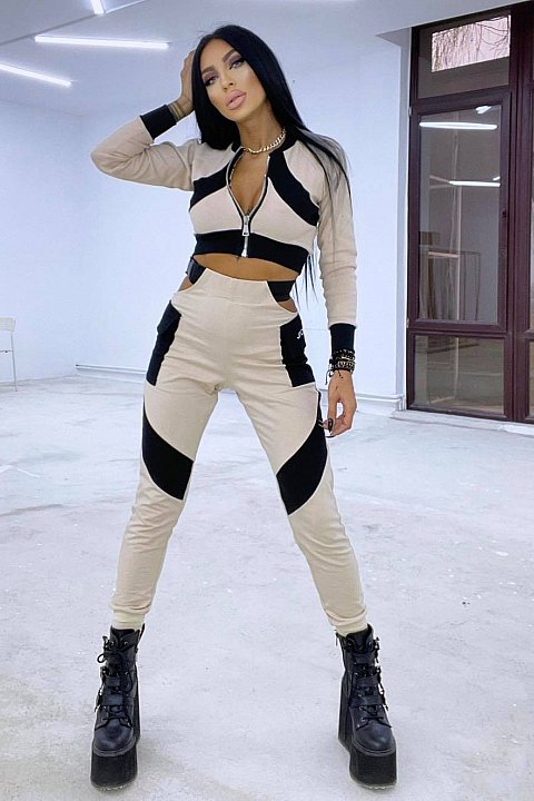 Sports suit in cream color with black inserts.