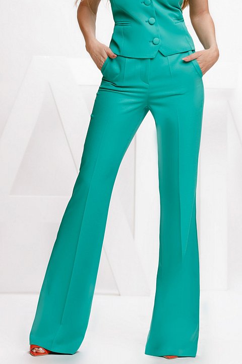 Flared trousers in light green cady.