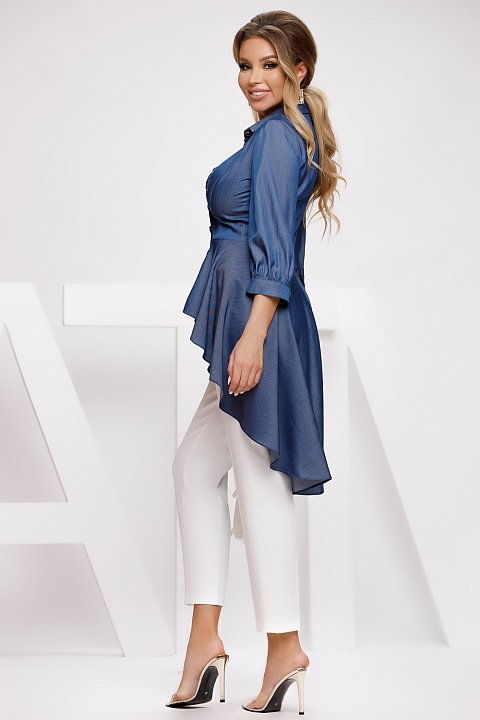 Asymmetrical denim shirt with modern cuts. The shirt is short in the front and long in the back, which gives it elegance.